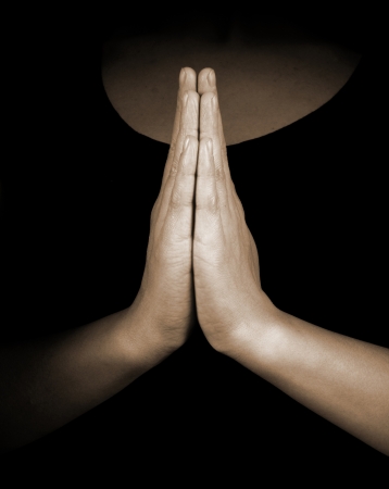 17607982 - praying hands on black background