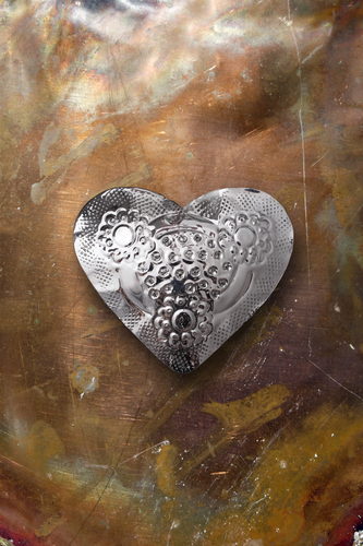 Chrome metal heart on tarnished copper