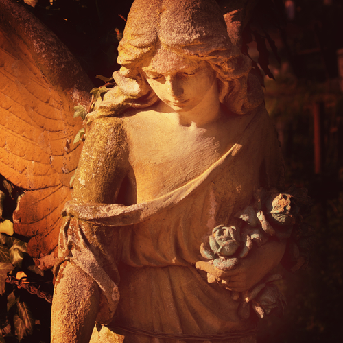 sculpture of an angel with dark background
